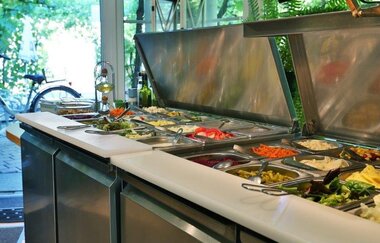 Buffet mit verschiedenen Salaten und kalten Speisen in einem Landgasthof mit Blick auf einen Fahrradständer draußen | © Landgasthof Taubertal