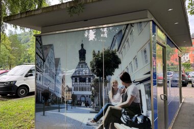 Auf die Toilette ist ein Bild mit zwei Frauen auf einer Bank aufgedruckt | © Touristikgemeinschaft Hohenlohe e. V.